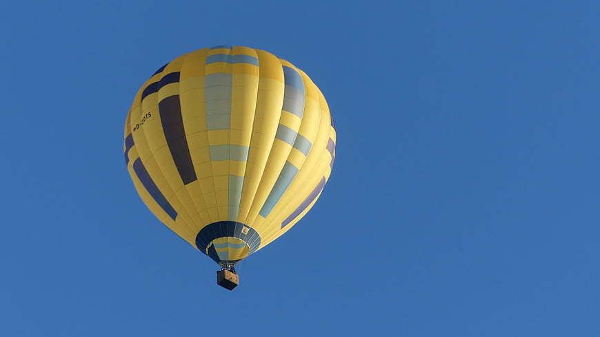 Yellow and Blue Hot Air Balloon in Clear Blue Sky
