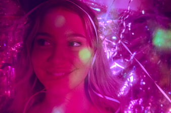 Young Woman Smiling in Neon Club Lights