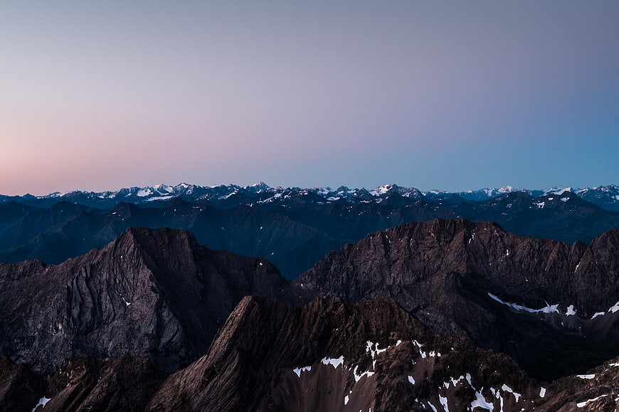 Majestic Mountain Range at Twilight with Snowy Peaks