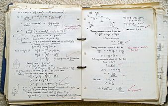 Vintage handwritten physics and math notes in a notebook