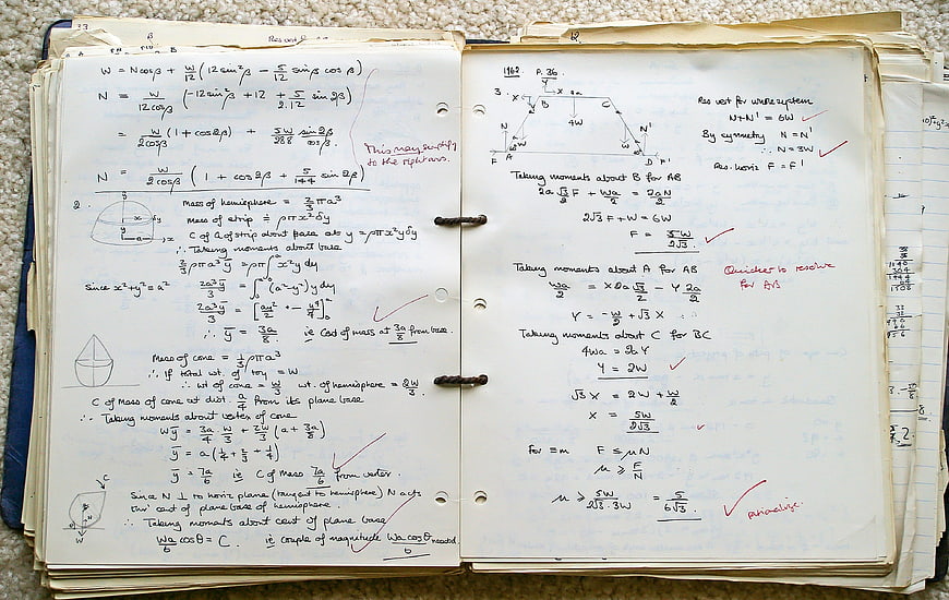 Vintage handwritten physics and math notes in a notebook