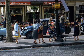 Vintage street scene with women waiting at a Parisian bus stop