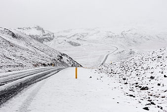 Snowy Mountain Road Winding Through Winter Highland Landscape