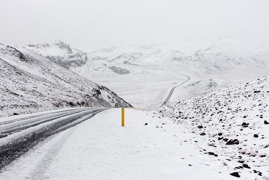 Snowy Mountain Road Winding Through Winter Highland Landscape