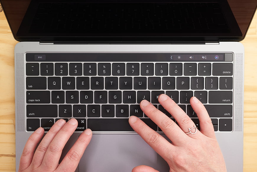 Top View of Hands Typing on Laptop Keyboard