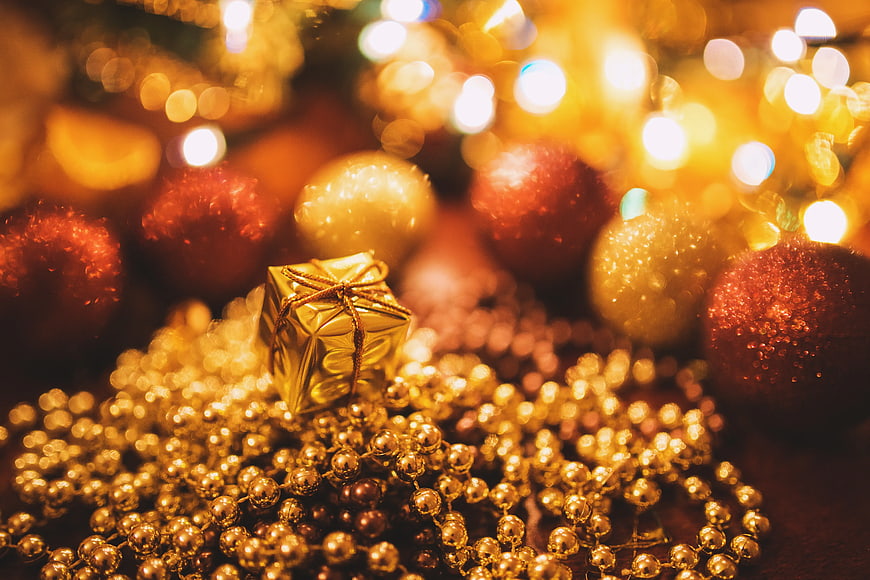 Tiny Gold Christmas Gift on Beads with Bokeh Lights