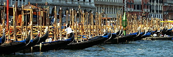 Gondolas docked in Venice Grand Canal with historic architecture