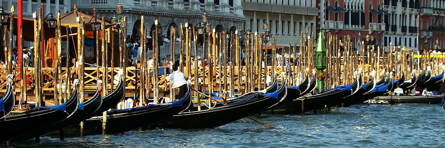 Gondolas docked in Venice Grand Canal with historic architecture
