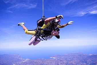 Tandem Skydiving Freefall Over Coastal Landscape
