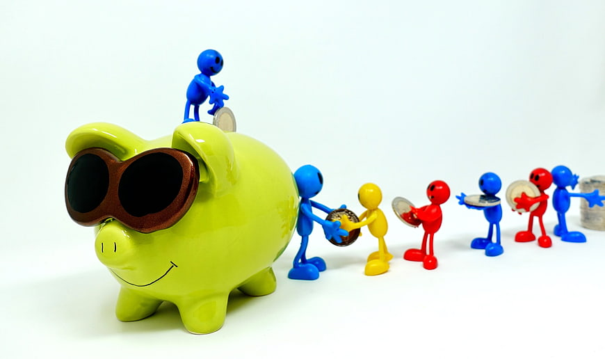 Green piggy bank with sunglasses and colorful figures saving money