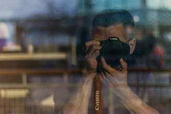 Photographer Taking Photo Through Glass Window Reflection