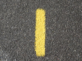 Yellow Number One Road Marking On Dark Asphalt Surface