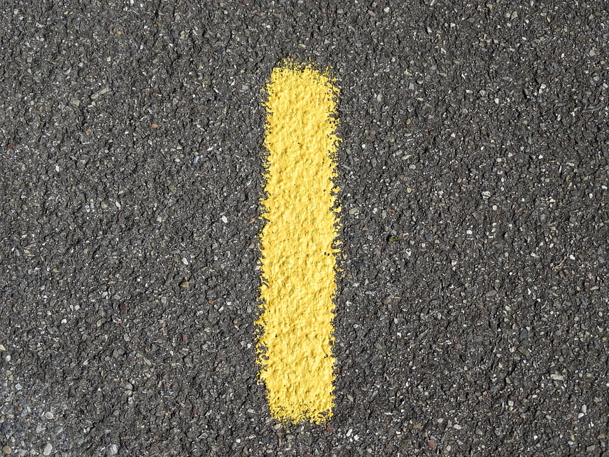 Yellow Number One Road Marking On Dark Asphalt Surface