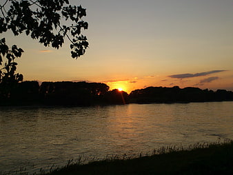 Serene Sunset Over River with Silhouetted Trees
