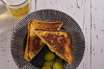 Top View of Grilled Cheese Sandwich with Pickles and Beer