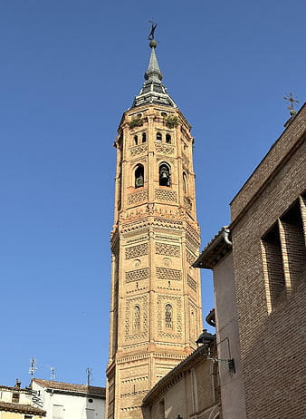 Historic Brick Bell Tower Against Blue Sky