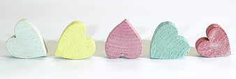 Pastel Wooden Hearts on White Background