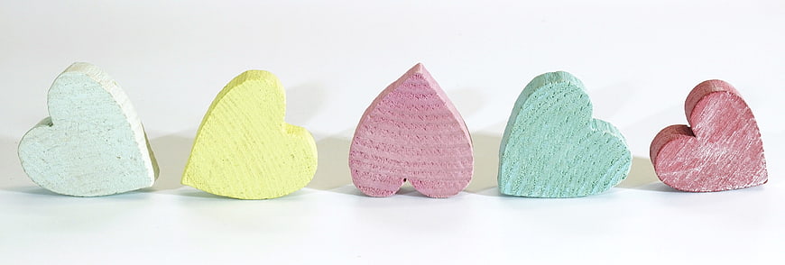 Pastel Wooden Hearts on White Background