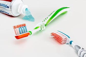Toothbrushes and Toothpaste on White Background