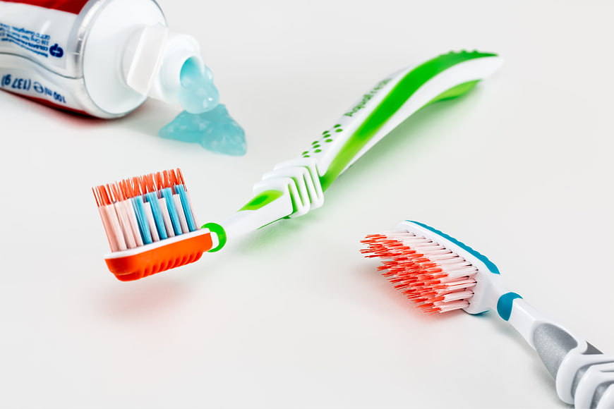Toothbrushes and Toothpaste on White Background