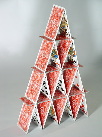 Tall House of Cards Structure on Gray Background