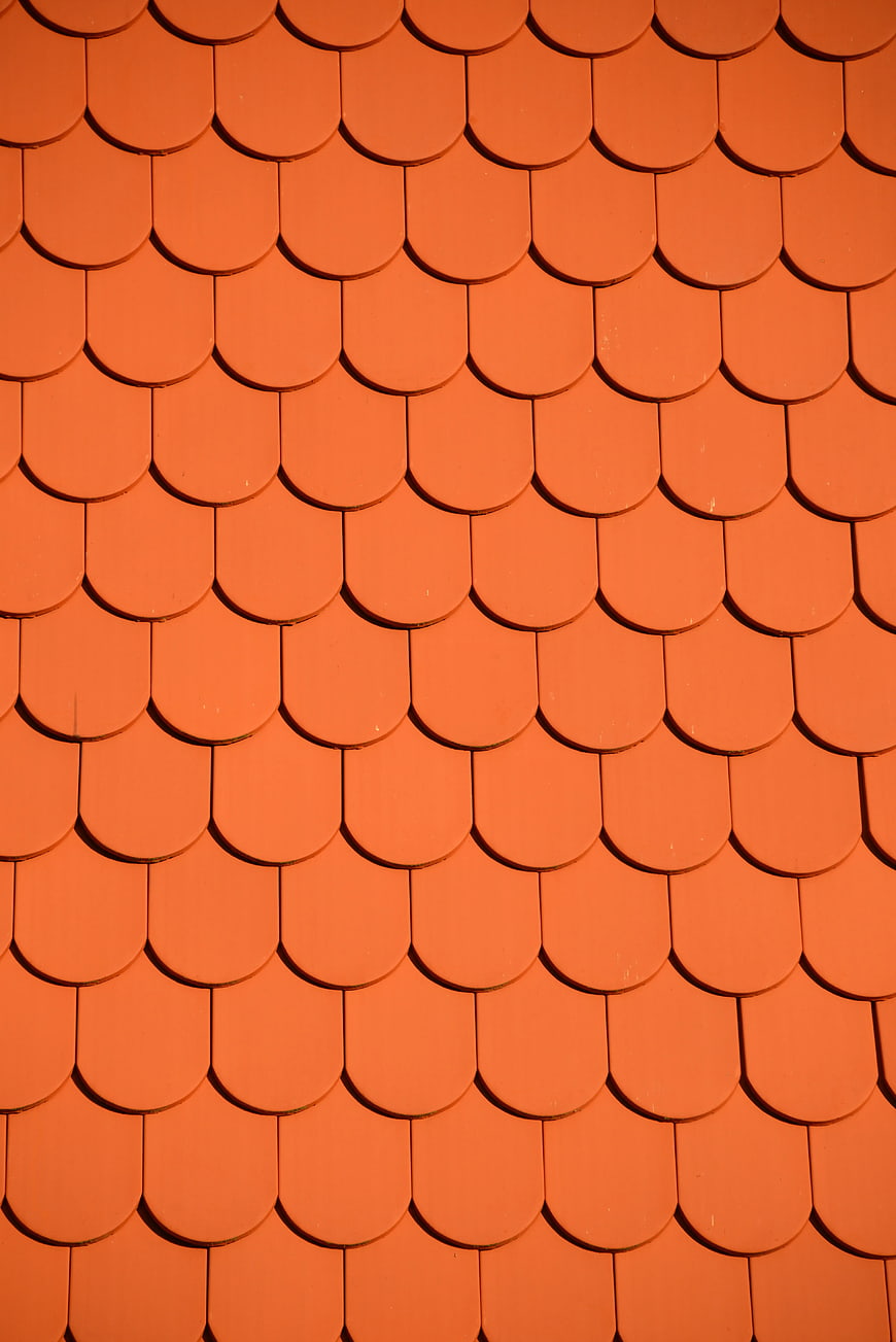 Close-up of orange scalloped roof tiles pattern