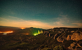 Pillars of the Holy Face illuminated at night under starry sky