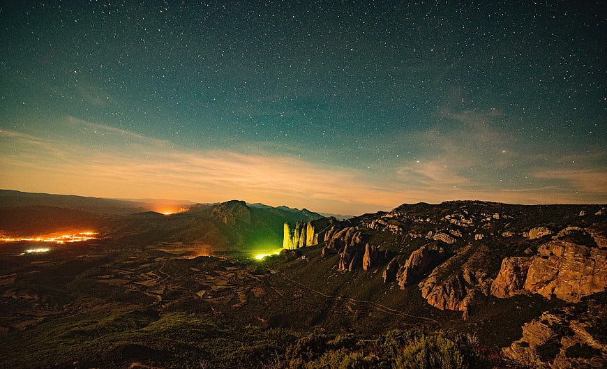 Pillars of the Holy Face illuminated at night under starry sky