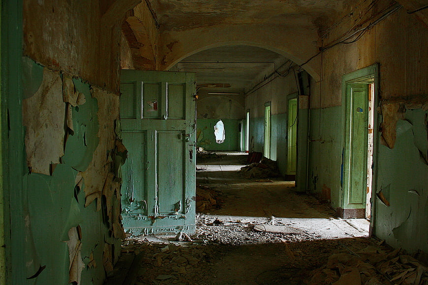 Abandoned Green Hospital Corridor with Peeling Paint