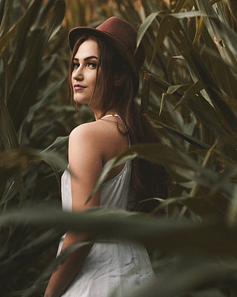 Woman in Fedora Hat Standing in Cornfield