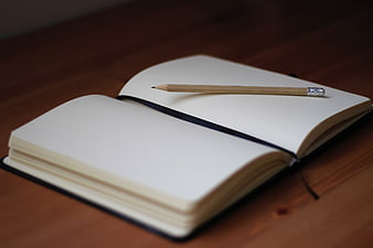 Open blank notebook with pencil on wooden desk