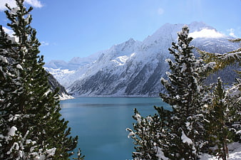 Snowy Pine Trees Framing Turquoise Alpine Lake