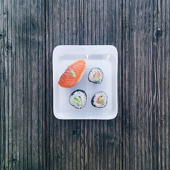 Minimalist sushi set on rustic wooden background top view