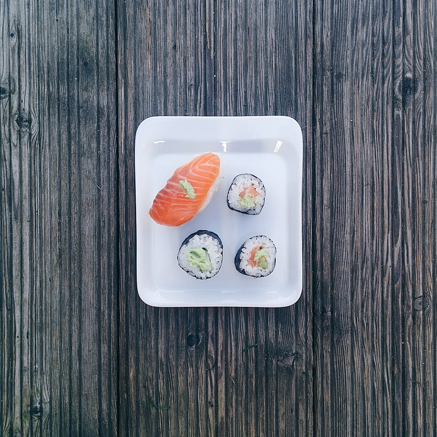 Minimalist sushi set on rustic wooden background top view