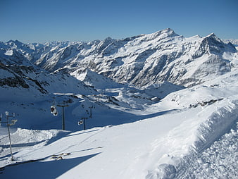 Snowy Alpine Ski Resort with Cable Cars and Mountain Peaks