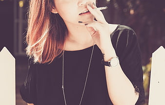 Close-up of Woman Smoking Cigarette Outdoors
