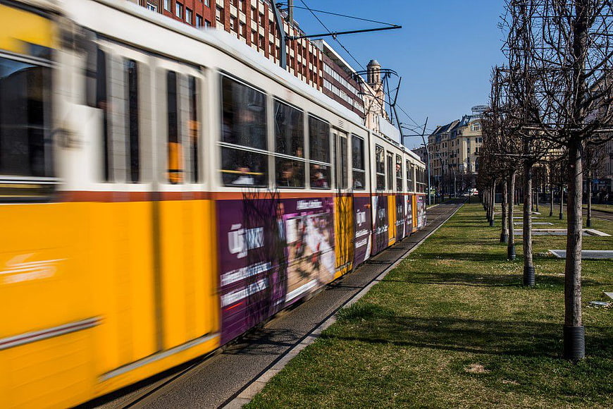 Yellow Tram in Motion on City Tracks