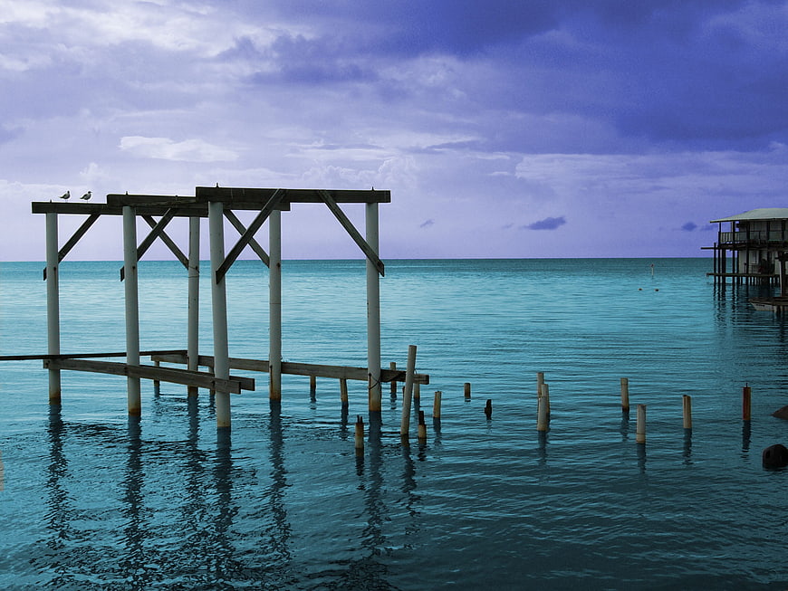 Weathered wooden pier structure in turquoise tropical ocean