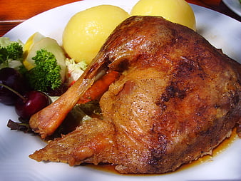 Roast Goose Leg With Dumplings And Salad On White Plate