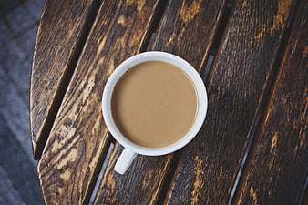 Top View of Coffee with Milk on Rustic Wooden Table