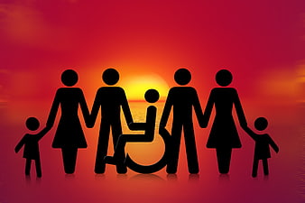 Silhouette of inclusive family with wheelchair user at sunset