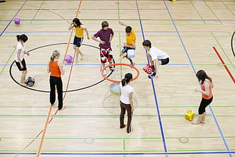 High angle view of children playing giant dice game in gym