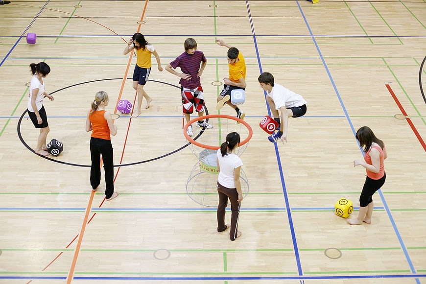High angle view of children playing giant dice game in gym