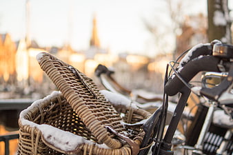 Snowy wicker bicycle basket in winter city