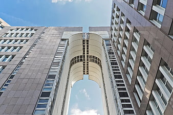 Low angle view of modern high-rise architecture with sky