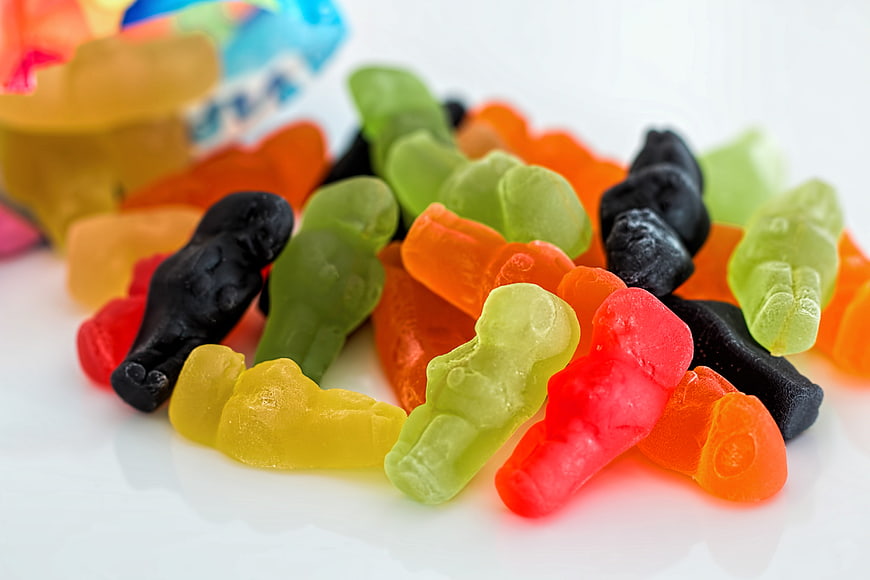 Colorful Jelly Baby Gummy Candy Assortment On White Background