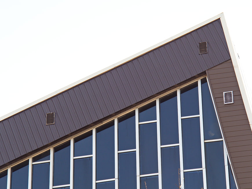 Modern Building Exterior with Blue Windows and Gray Siding