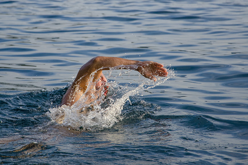 Man Swimming Freestyle in Ocean Water