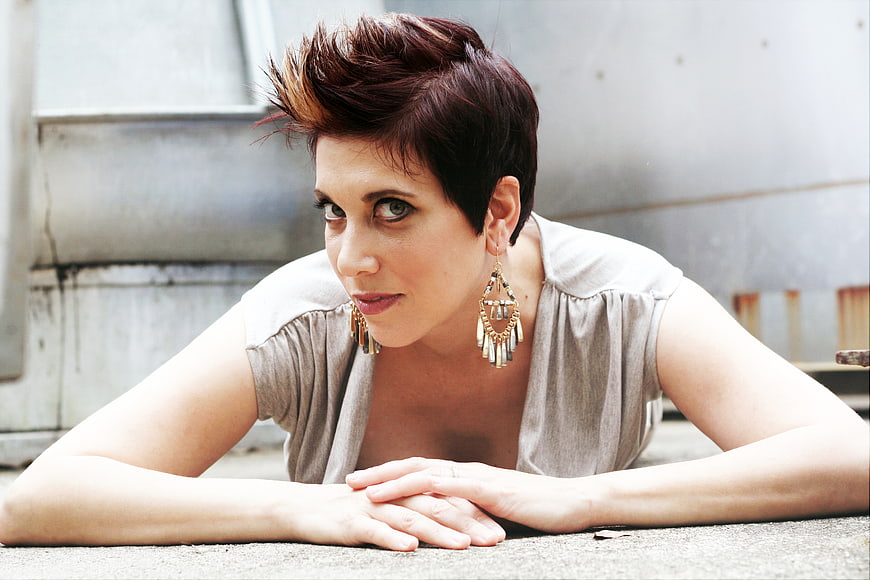 Portrait of woman with short spiky hair and statement earrings