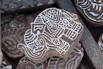 Traditional wooden block printing stamp with intricate carved patterns